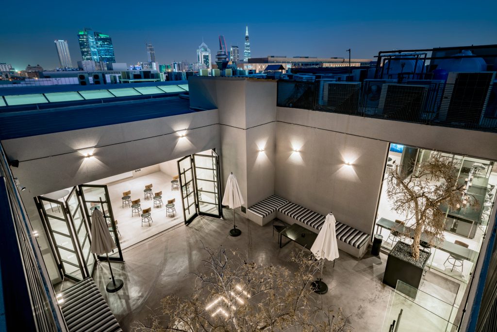Outdoor terrace at R House coworking space in Riyadh with seating and greenery